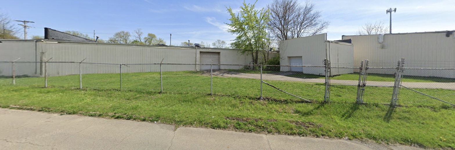 Street view of the warehouse and drive-in doors from W 18th Street
